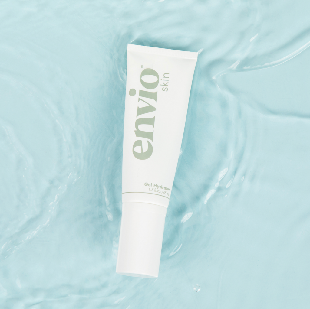 Image of the Envio Skin Gel Hydrator sitting in shallow water over a light blue background